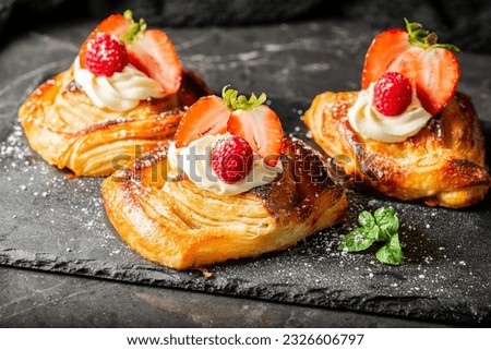 Delicious flaky fresh baked Danish Pastry with Chantilly cream and fresh fruit. 商業照片 © 