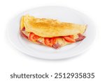 Delicious folded omelette filled with cheese, ham and tomatoes, served on a white plate, isolated on a white background