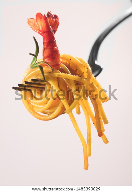 delicious fork wrapped in spaghetti with tomato\
sauce and seafood