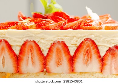 Delicious Fraisier Cake with a Genoese Sponge and Diplomat Cream, decorated with fresh strawberries and topped with Panna Cotta. 