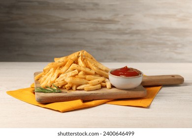 Delicious french fries served with sauce on white wooden table - Powered by Shutterstock