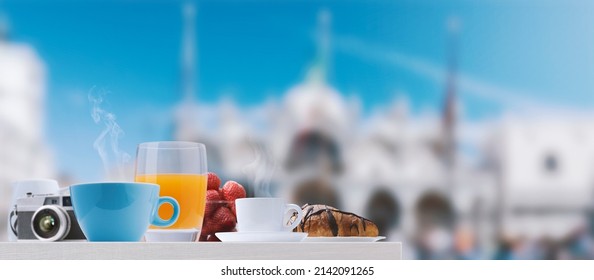 Delicious fresh breakfast in Venice and view on St Mark's Square in the background, travel and healthy eating concept