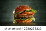 Delicious fresh cheeseburger with old grey background. Fresh american kitchen.