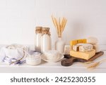 Delicious fresh dairy products for Shavuot on a wooden cutting board and a white table. A vase with ears of corn. Concept of a Jewish holiday.