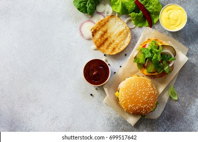 A Delicious Fresh Homemade Hamburger On A Slate Or Stone Table. Cheeseburger With Meatball And Vegetables. Street Food, Fast Food. Top View With Copy Space.