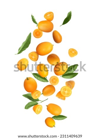 Delicious fresh kumquats and green leaves falling on white background