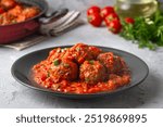 Delicious fresh meatballs in tomato sauce with salt, spices and herbs 