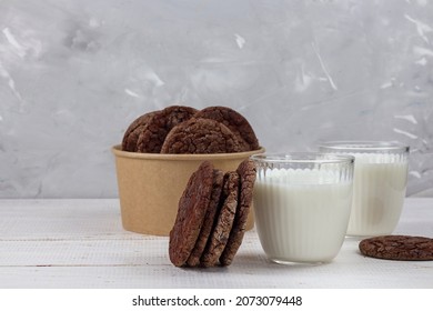 Delicious fresh milk on an old wooden background. A jug of milk and a bottle of milk. Chocolate chip cookies. Eco packaging. copy space - Powered by Shutterstock