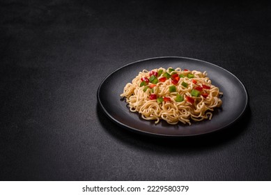 Delicious fresh noodles with sweet pepper, tomato, spices and herbs. Asian cuisine - Powered by Shutterstock