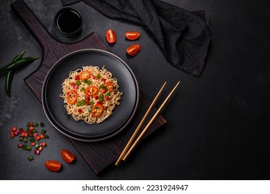 Delicious fresh noodles with sweet pepper, tomato, spices and herbs. Asian cuisine