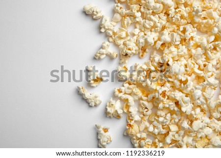 Similar – woman with popcorn in hand on yellow background. Copyspace