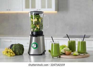 Delicious fresh smoothie and blender with ingredients on white marble table in kitchen - Powered by Shutterstock