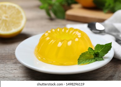 Delicious fresh yellow jelly with mint on wooden table - Shutterstock ID 1498296119