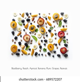 Delicious Fruit And Berry Background. Sliced â??â??banana, Apricot Halves, Nuts, Blackberries And Grapes On A White Background. Pattern Of Food. Yummy Texture. View From Above.
