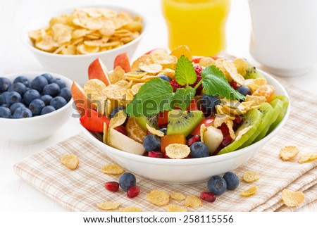 delicious fruit and berry salad for breakfast, close-up, horizontal