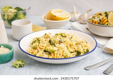 Delicious fusilli pasta with broccoli and cheese in bowl on light background, closeup - Powered by Shutterstock