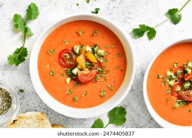 Delicious gazpacho soup in bowl over light stone background. Cold summer soup. Top view, flat lay - Powered by Shutterstock