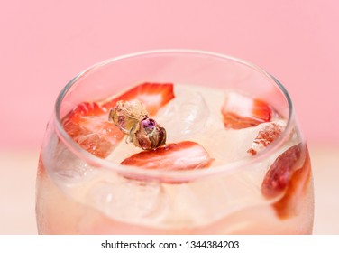 Delicious Gin Tonic cocktail decorated with strawberry and mini roses on a pink background. Aromatic drink.  - Shutterstock ID 1344384203