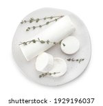 Delicious goat cheese with thyme on white background, top view