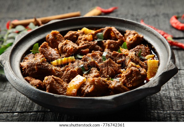 Delicious\
goat meat curry served in a clay cookware\
.