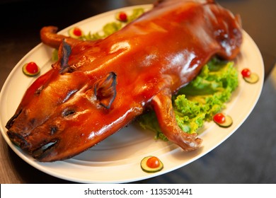 Delicious, Golden Roasted BBQ Suckling pig Cantonese Style made from a piglet that turned into Chinese delicacy which its cooked skin is very crispy and the meat is tender and juicy. Selective Focus. - Shutterstock ID 1135301441