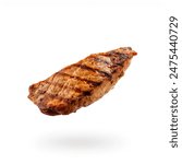 Delicious Grilled chicken breast isolated on white background. Chicken steak fillet grilled. Cooked Chicken breast meat flying in the air. Floating grilled meat fillet, steak. Grilled chicken steak.
