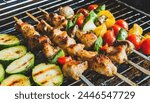 delicious grilled chicken meat shish kebob or kabob with vegetables on barbecue grill with smoke and flames. popular outdoor summer activity for friends and family