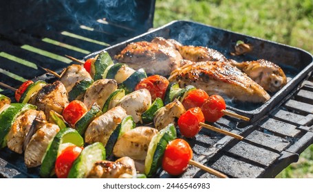 delicious grilled chicken meat shish kebob or kabob with vegetables on barbecue grill with smoke and flames. popular outdoor summer activity for friends and family - Powered by Shutterstock