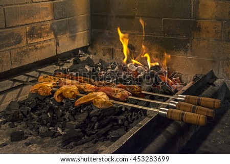 Delicious grilled chicken and pork skewers on fire 
Perfect background for a text