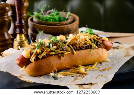 Delicious grilled hotdog in a restaurant, Homemade Bacon Wrapped Hot Dogs with Onions and Peppers