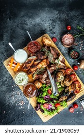 Delicious Grilled Meat With Vegetable. Mixed Grilled Bbq Meat With Vegetables On Wooden Platter. Restaurant Menu, Dieting, Cookbook Recipe Top View,