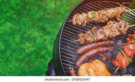  Delicious grilled meat with vegetables sizzling over the coals on barbecue. Grilling in summer with copy space concept. - Powered by Shutterstock