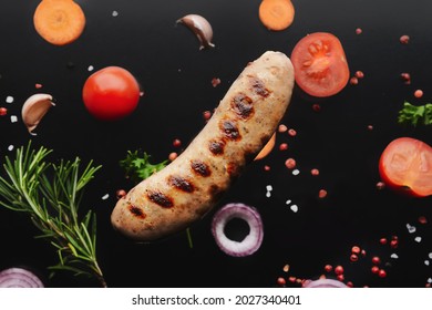 Delicious Grilled Sausage And Vegetables On Dark Background