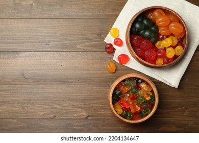 Delicious Gummy Candies On Wooden Table, Flat Lay. Space For Text