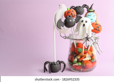 Delicious Halloween themed cake pops on pink background, space for text - Powered by Shutterstock