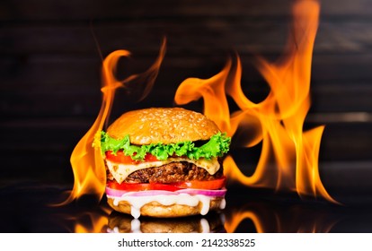 Delicious Hamburger Burger With Flame On A Dark Background