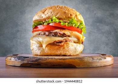 Delicious Hamburger On Wooden Table With Gray Background - Front View.