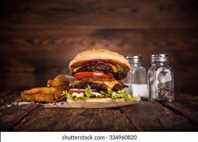 Delicious hamburger served on wooden planks