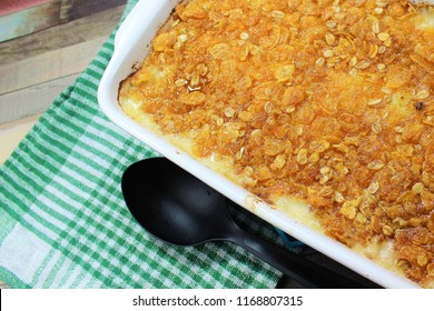 Delicious Hash Brown Casserole With The Butter Cereals On The Top And Melted Cheese In The White Dish With The Colorful Plate And A Colorful Background Ready For A Family Dinner