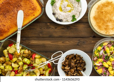 Delicious Healthy Dishes Of Cornbread, Cooked Mushrooms And Potato Salad Frame Wooden Table