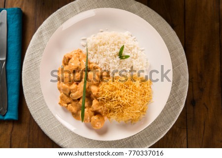 Delicious healthy food with chicken strogonoff with rice and french fries on dish. View from the top.
