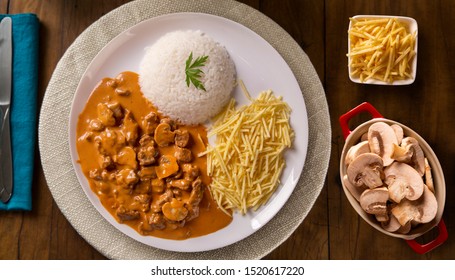 Delicious healthy food with meat strogonoff with rice and french fries on dish. View from the top.
