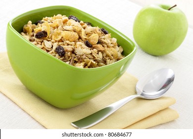 delicious and healthy wholegrain muesli breakfast, with lots of dry fruits, nuts, grains and a fresh apple