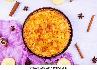 Delicious Homemade Apple Pie On Pink Background. Apple Pie With Ingredients, Apples And Cinnamon. Top View