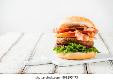 Delicious Home-made Bacon Burger On White Wooden Background, Copyspace