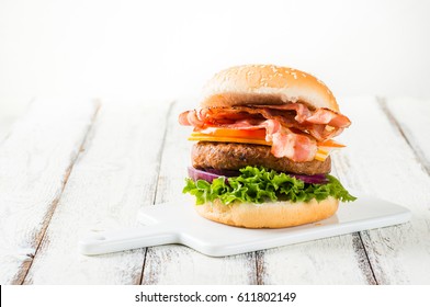 Delicious Home-made Bacon Burger On White Wooden Background, Copyspace