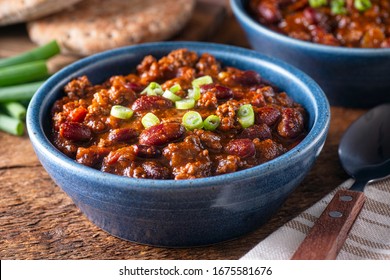 Delicious homemade beef chili con carne with green onion garnish. - Shutterstock ID 1675581676