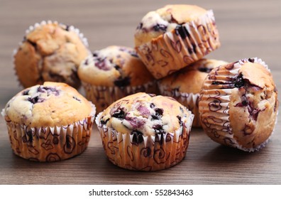 Delicious home-made blueberry muffins on a wooden background