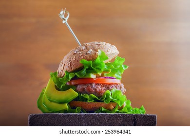 Delicious homemade burger on rustic wooden desk  - Shutterstock ID 253964341