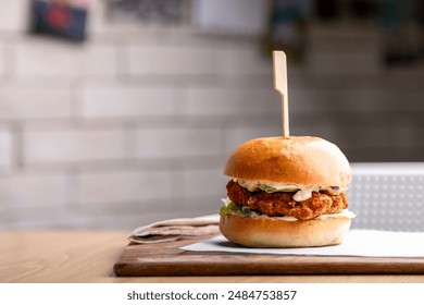 Delicious homemade chicken burger. A juicy and flavorful grilled chicken patty, seasoned to perfection, nestled in a soft, toasted bun. Topped with fresh lettuce, ripe tomatoes, and crispy pickles - Powered by Shutterstock